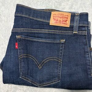 Levi ladies capri jeans, size 33. Traditional threading in golden yellow.